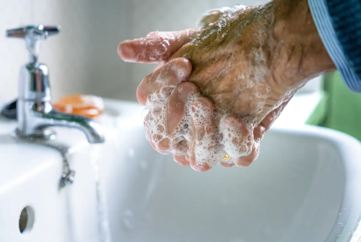 close up of a person washing their hands with soap